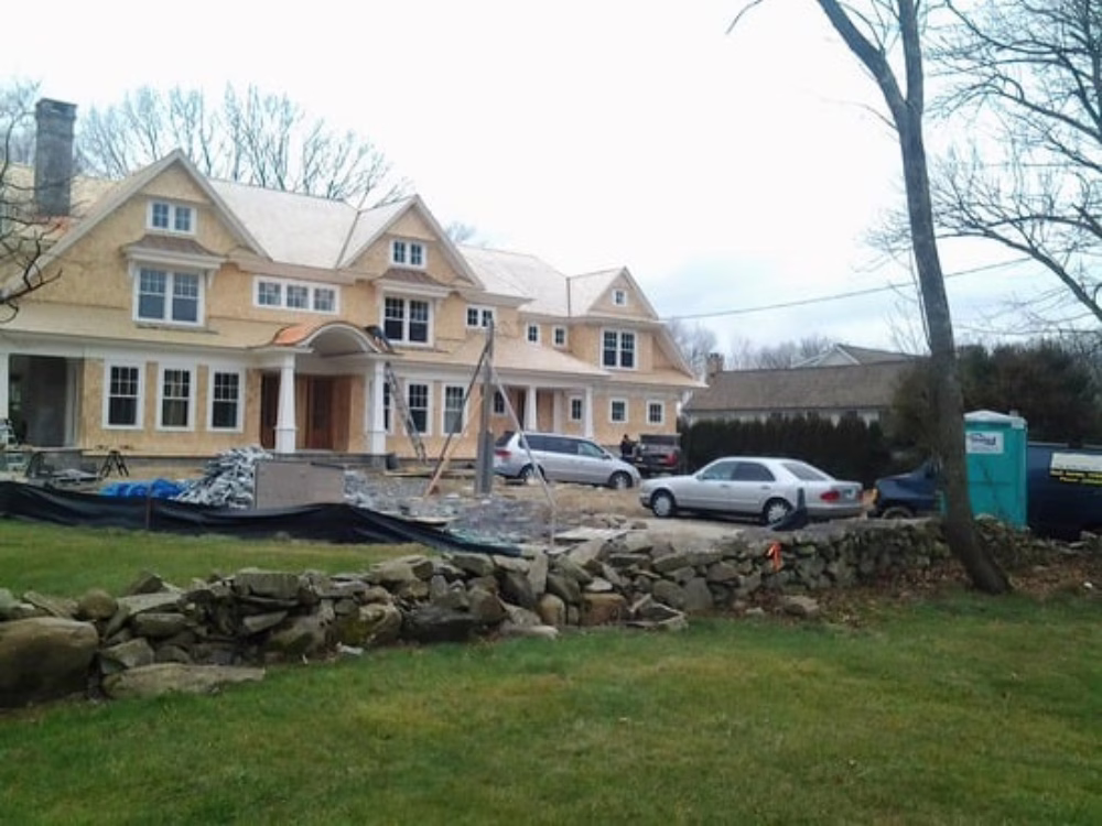 Wide view of siding installation project with multiple dormers and gables